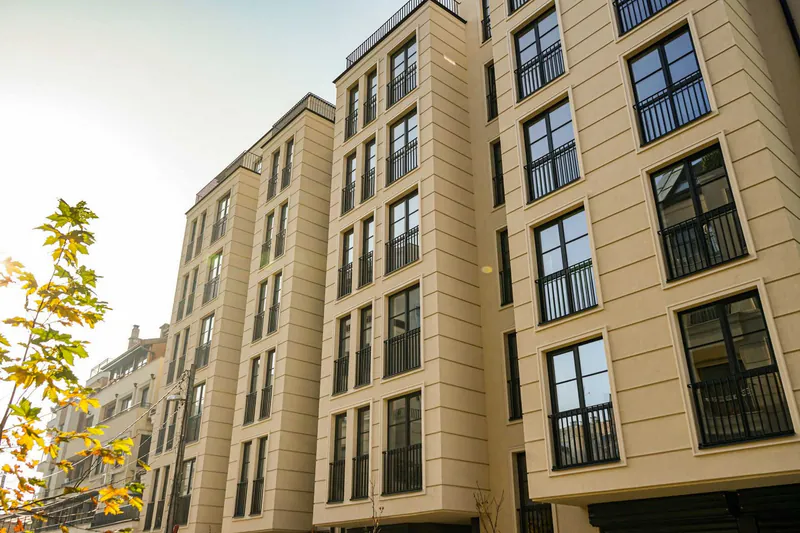 Stone-clad residential facade with tall windows