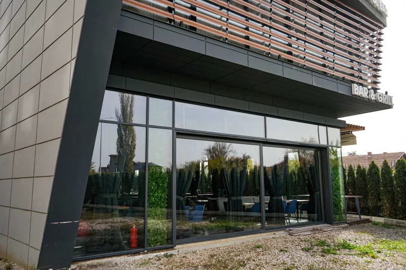 Large commercial glazing beneath a dark facade