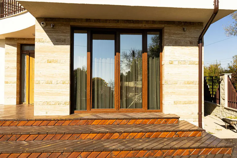 Windows and doors opening onto a timber terrace