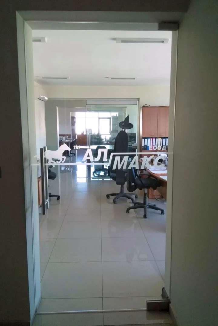 Glass door with the AL MAX company logo