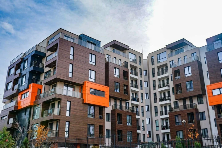 Residential complex with timber and orange facade accents