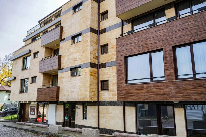 Residential building with stone and timber cladding